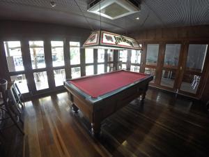 a pool table in a room with a ceiling at Global Backpackers Youth Hostel in Port Douglas