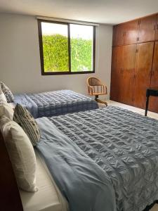 a bedroom with two beds and a window at Villa Nola in Guatemala +14 photos