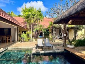 a villa with a swimming pool and a house at Searenity Villa in Grand-Baie