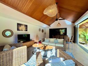 a living room with a couch and a table at Searenity Villa in Grand Baie
