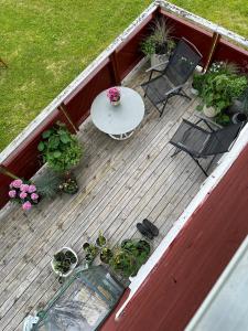 a deck with a table and chairs and potted plants at 3ART recreation in Tromsø
