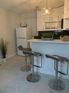 a kitchen with two bar stools in front of a counter at La Casita in Miami