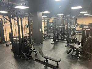 a gym with several rows of equipment and machines at High Point 2 bed Apartment in Bradford +1 photo