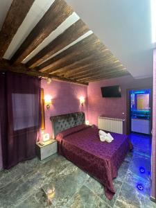 a bedroom with a purple bed in a room at Venice Rainbow Apartments BIENNALE in Venice