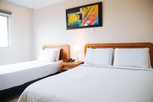 Voodi või voodid majutusasutuse Hotel Genova Centro toas