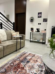 a living room with a couch and a table at Orchid Villa salalah in Salalah
