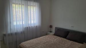 a bedroom with a bed and a large window at Villa Mine Blagaj in Blagaj +18 photos