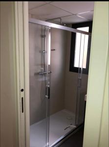 a shower in a bathroom with a glass door at Luxury Apartment in Fuengirola