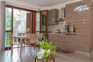 a kitchen with a table and chairs in a room at Casa Bonita Rho in Rho