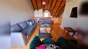 a living room with a couch and a table at Mond Kleine Guest House in Kleinmond