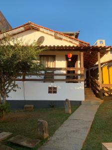 a white house with a pathway in front of it at Vicentina Hospedagem in Tiradentes