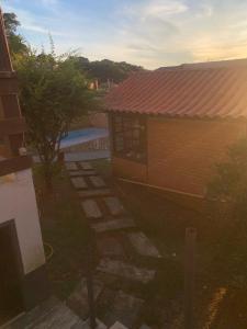 a small house with a yard and a building at Vicentina Hospedagem in Tiradentes