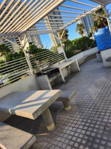 a bench sitting in front of a building at Depto Marina Costa a pasos de ENJOY in Coquimbo +2 photos