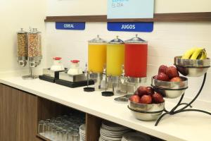 a counter with some drinks and bowls of fruit at Holiday Inn Express Manzanillo by IHG in Manzanillo +70 photos