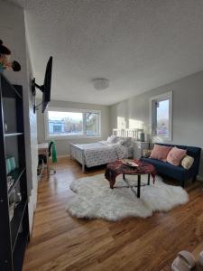 a living room with a couch and a table at Heart to Downtown - Bright and Sunny Ultra Premium Queen bedroom in Calgary