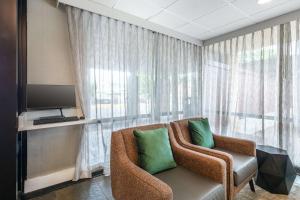 a living room with a chair and a computer monitor at Best Western Plus Laurel in Laurel