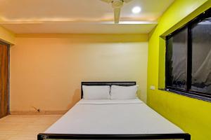 Postel nebo postele na pokoji v ubytování Hotel O NANDAN