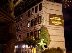 a hotel building with a sign on it at night at Kadi Konagi Thermal Hotel in Bursa