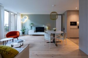 a living room with a table and chairs at The Central City - Luxury Serviced Residence in Luxembourg +116 photos