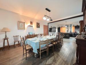 a dining room with a table and chairs and a kitchen at La Usine du Charme in Saint-Menges +36 photos