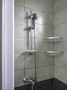 a shower with a glass door with a shower head at Villa Alexis - Location de vacances à Trou aux Biches in Trou aux Biches +33 photos