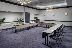 a conference room with tables and chairs and a chandelier at Courtyard New York Manhattan/Times Square in New York
