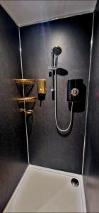 a bathroom with a shower on a wall at Liverpool House Near City Centre in Liverpool