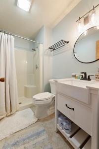 a bathroom with a sink and a toilet and a shower at Smokey Hollow's Secret Hot Tub Beach AC in Traverse City