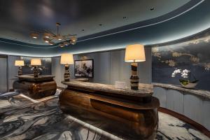 a hotel lobby with two tables and a chandelier at JW Marriott Essex House New York in New York +37 photos