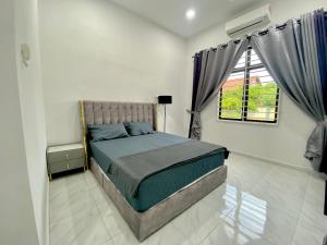 Voodi või voodid majutusasutuse Homestay Bendang Morak toas