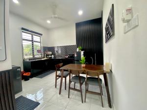 a kitchen and dining room with a table and chairs at Homestay Bendang Morak-Musl!m Only in Wakaf Baharu