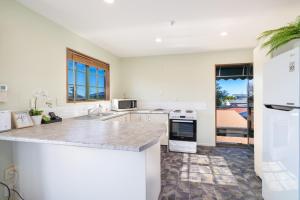 a kitchen with white appliances and a counter top at Great Location, Affordable, Units in Kaikoura