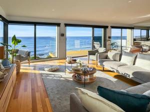a living room with a view of the ocean at Ava - Luxe Oceanfront Beach House in Falmouth