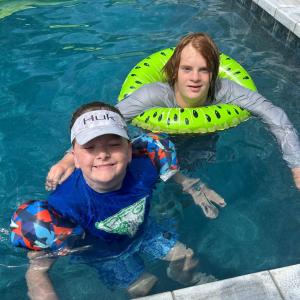 two men in the swimming pool in the water at W2Beach 4TVs Roku Pets WC WiFi 4King ßds grill games in Hilton Head Island