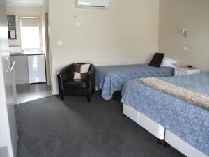 Säng eller sängar i ett rum på Scenicland Motels