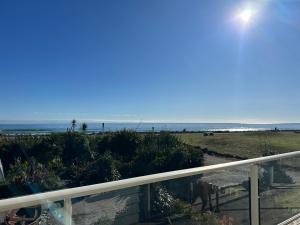 a view of the beach from a balcony at Sailor's Catch in Hokitika