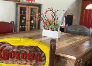 a wooden table with a vase of flowers on it at Casa de Amigos in Alpine