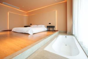 A bed or beds in a room at Sandstone Painting Handicraft Exchange Gallery Hotel