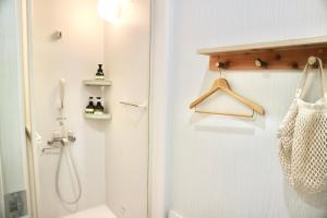 a bathroom with a shower and a toilet and a sink at ペコレラ学舎 Pekolela YAKUMO in Yakumo +15 photos