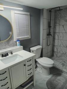a bathroom with a toilet and a sink and a shower at Stunning 2 bedroom and 2 bath mobile home in Doylestown +17 photos