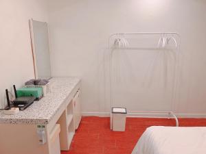 a bedroom with a shower and a bed and a counter at Dongdaemun Karrot Hostel in Seoul
