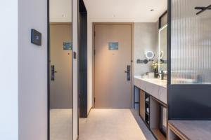 a bathroom with a sink and a mirror at Atour Hotel Mawangdui Wanjiali Middle Road in Changsha