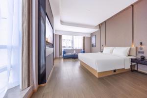 Tempat tidur dalam kamar di Atour Hotel Changsha Xingsha Economic Development Zone Sanyi Road