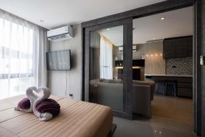 a bedroom with a bed with two swans on it at Modern Condo in Boutique Style Resort CGB4 in Phuket Town