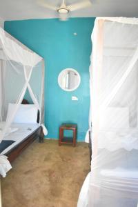 Ένα ή περισσότερα κρεβάτια σε δωμάτιο στο La Neisha Hotel Nungwi +22 φωτογραφίες
