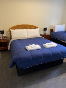 Postel nebo postele na pokoji v ubytování Kowhai Lodge