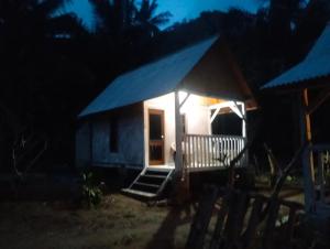 a small house with a blue roof at night at ATUH GARDEN Silent Glamping in Klungkung