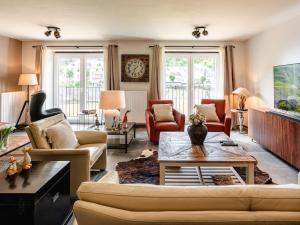 a living room with a couch and a table at Villa Steps from Castle in Bouillon