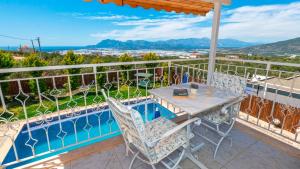 a patio with a table and chairs on a balcony at Villa atılgan in Kaş