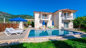 a villa with a swimming pool and a house at Villa atılgan in Kaş